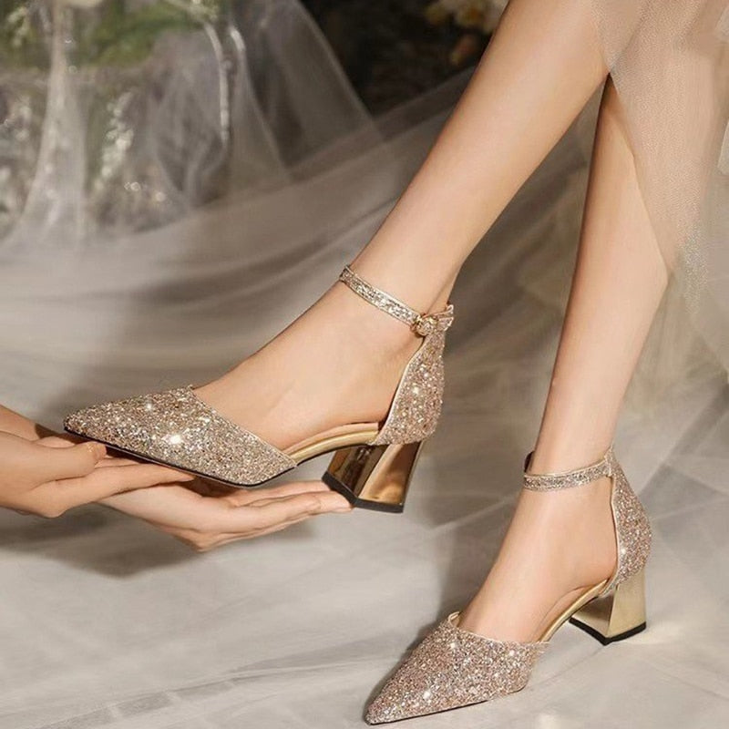 Gold wedding rings between pair of golden high heel shoes. Wedding details  on mirror floor near panoramic window. Close up. Macro. On sunshine Stock  Photo by ©ivan.kryvoshei 335644496